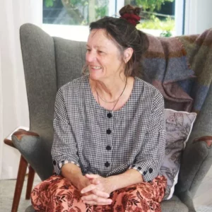 Annie Chapman, empathy practitioner, sitting in a chair smiling