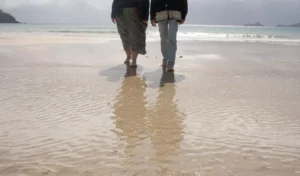 Man and woman walking along the beach